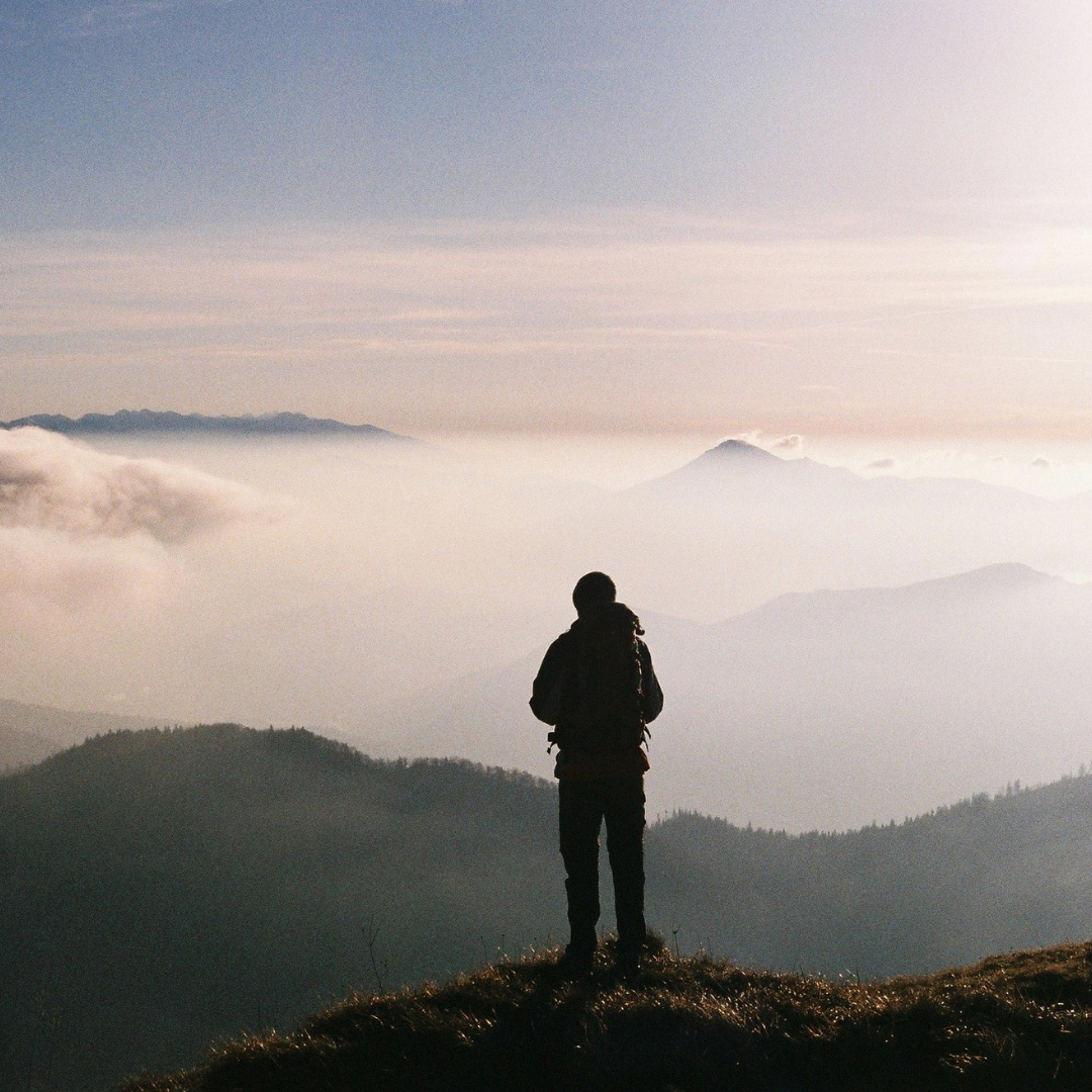 Man looking out at mountains