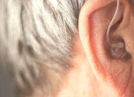 hearing aid in elderly mans ear