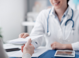 Doctor giving patient a prescription