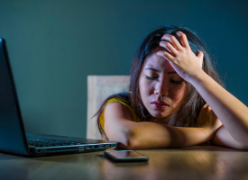 Stressed woman ignoring laptop and phone