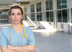 Female doctor standing outside a hospital