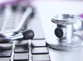 stethoscope on top of laptop