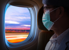 Image of passenger wearing mask in plane