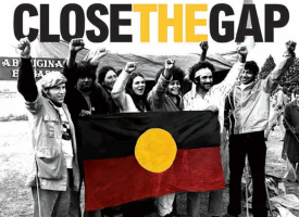 An old picture of First Nations people raising their hands in power at the tent embassy 