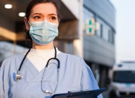 Health care worker in front of ambulance