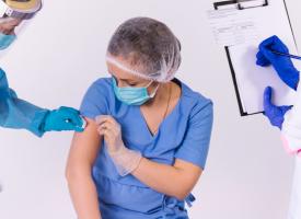 Image of health care worker being vaccinated