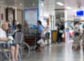 Blurred image of people in hospital waiting room