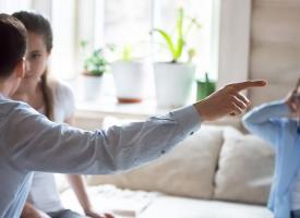 Man pointing finger and upset child