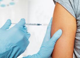 Needle injecting vaccine to a person