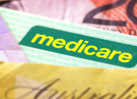 Medicare card with $50 note 
