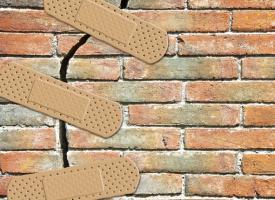 Image of Band-Aids over a cracked brick wall