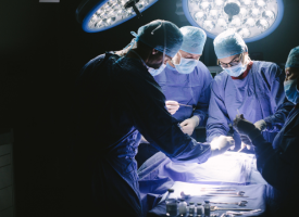 Four surgeons operating in a surgical theatre