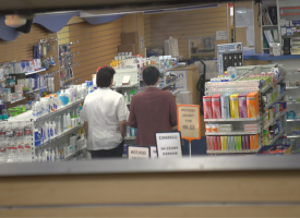 Image of pharmacist with person in store