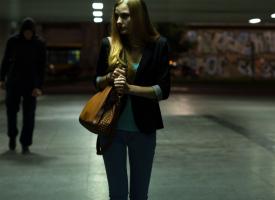 Nervous woman walking alone at night