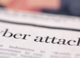 Image of newspaper headline on cyber attack