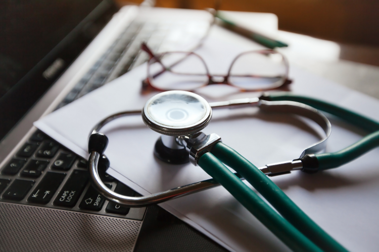 Stethoscope resting on laptop