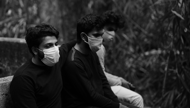 three men with COVID-19 masks in India
