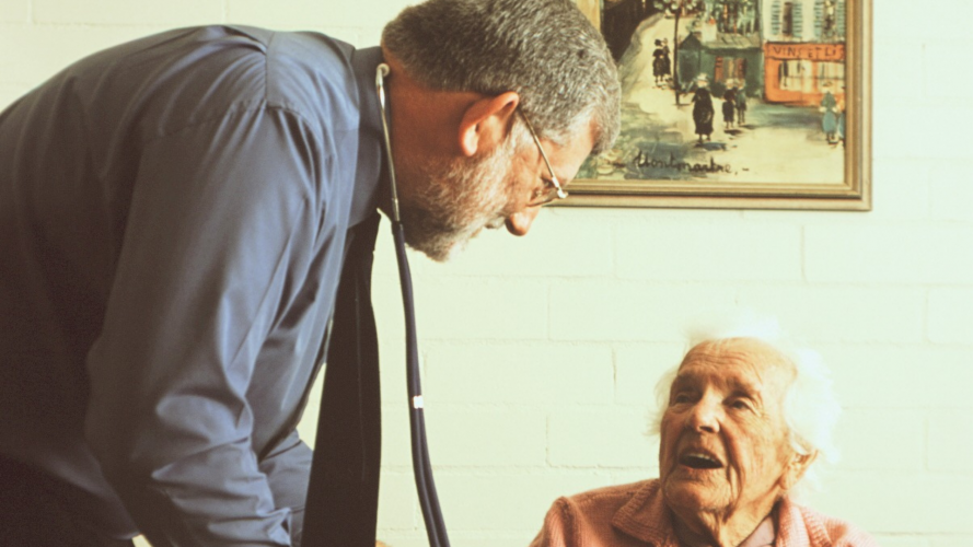 GP talking to aged care resident