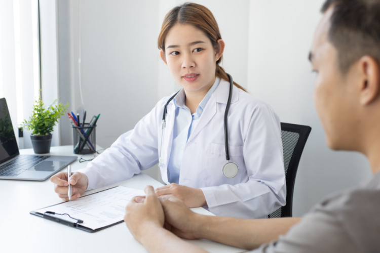 young female doctor consulting with a male patient 