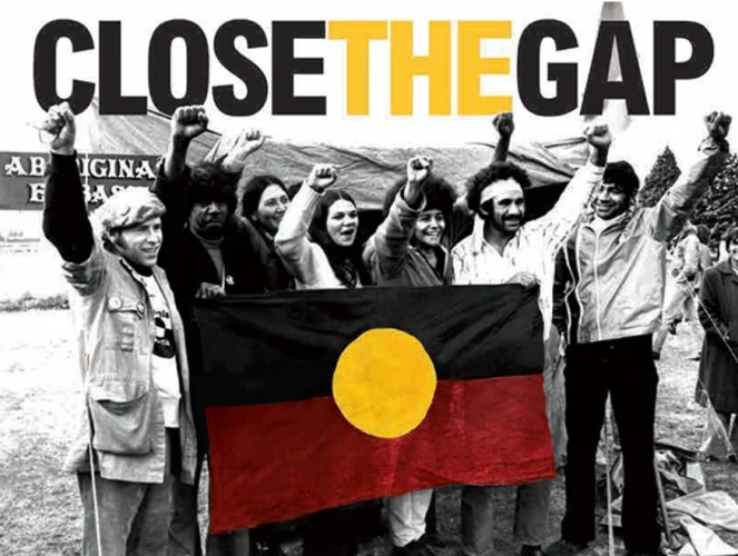 An old picture of First Nations people raising their hands in power at the tent embassy 