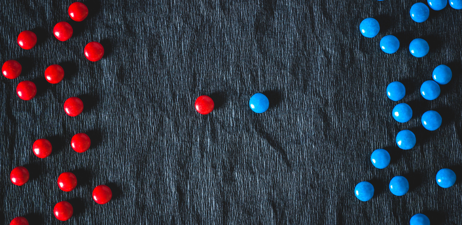 red smarties on left blue smarties on right one red and one blue in the middle 