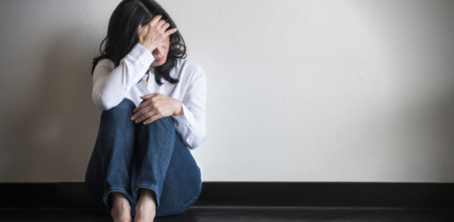 Woman sitting against wall