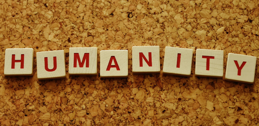 the word humanity written on blocks in red ink