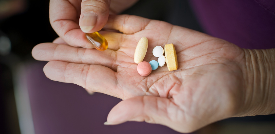 Elderly hands with medications