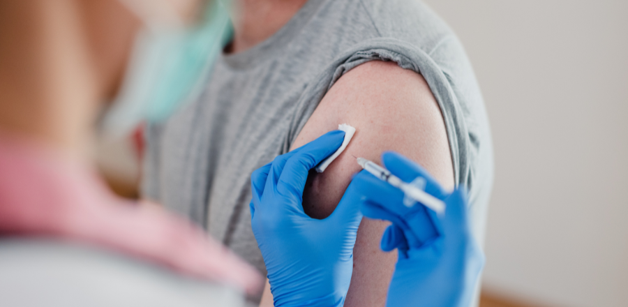 Close up of flu vaccine administered in a man's arm