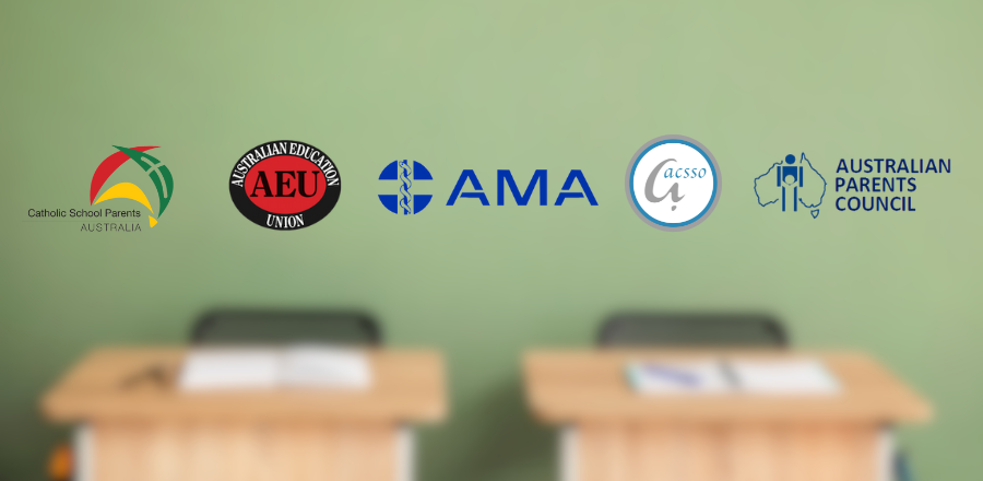 AMA and education group logos on a blurred background showing two school desks