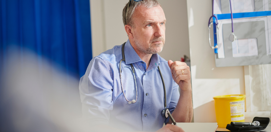 General practitioner doctor working at desk